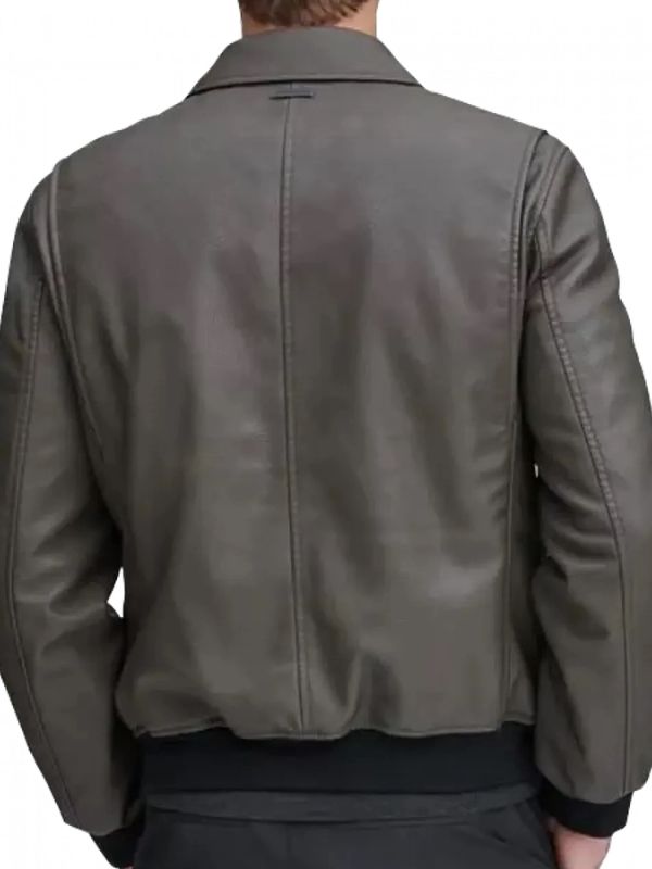 Green leather jacket worn by a person on a white background