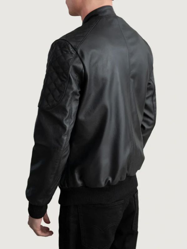 Person wearing a black leather jacket on a light gray background