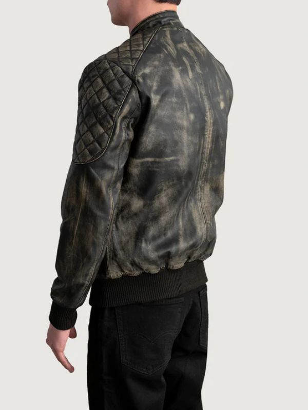 Person wearing a distressed leather jacket on a plain background