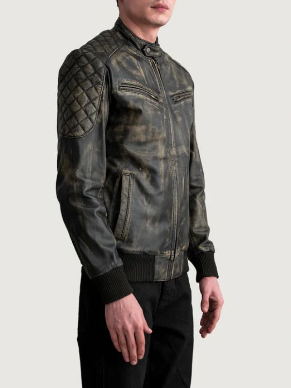 Man wearing a dark leather jacket with quilted shoulder design on a light gray background