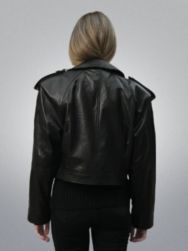 Person wearing a black leather jacket on a gray background