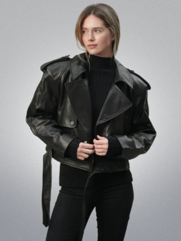 Person wearing a black leather jacket and black outfit on a gray background