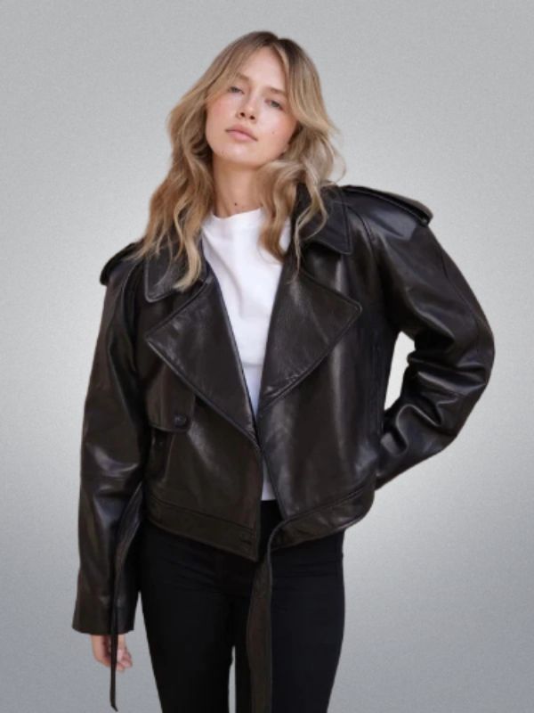 Woman wearing a black leather jacket on a gray background