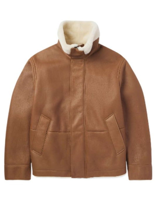 A luxurious men's tan-colored aviator jacket featuring a cream-colored shearling collar and interior lining, two front patch pockets, and a zippered front closure with a buttoned placket. The jacket is crafted from supple leather or suede, exuding warmth and sophistication.